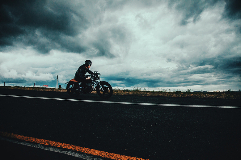 骑摩托车男子公路云朵