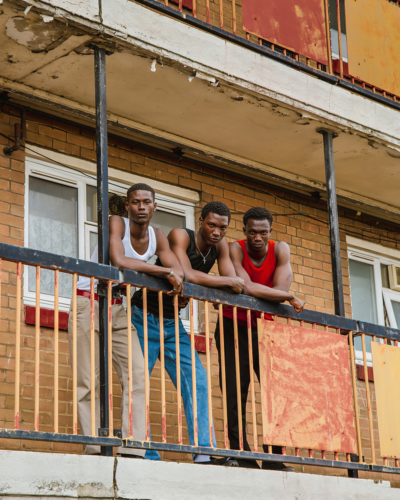 三个人站在一栋楼的阳台上