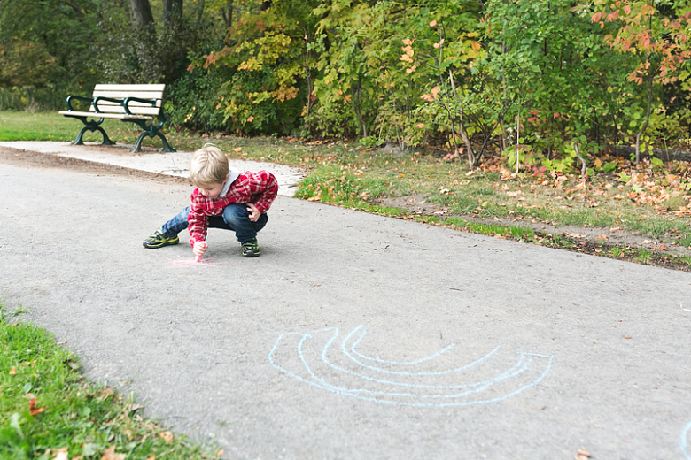 男孩在公园用粉笔画画