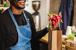 手拿萝卜开心大笑的男生