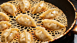 煎锅中金黄饺子美食摄影