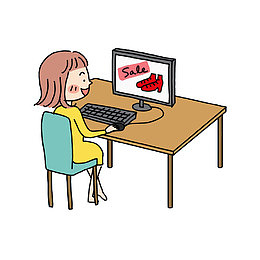 坐在桌子前玩电脑的女孩