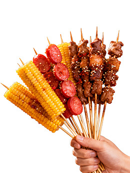 手握多串烧烤食材图片