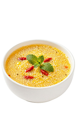 一碗装饰有薄荷叶的黄色粥