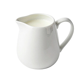 白色瓷壶盛装牛奶图片