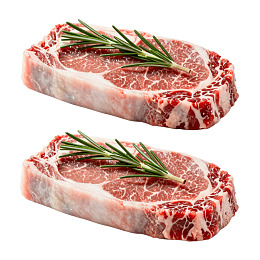 两块带迷迭香装饰的生牛排