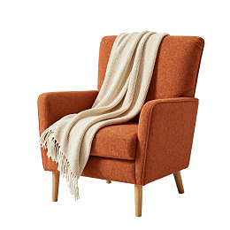 橙色扶手椅搭米色毯子